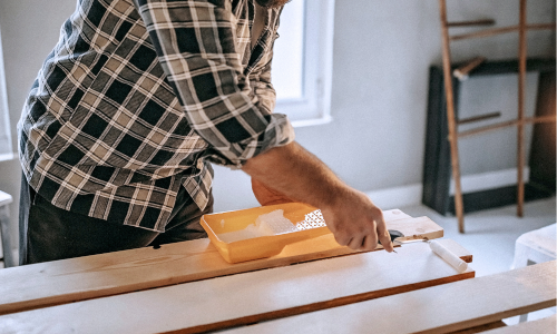 Man painting wood