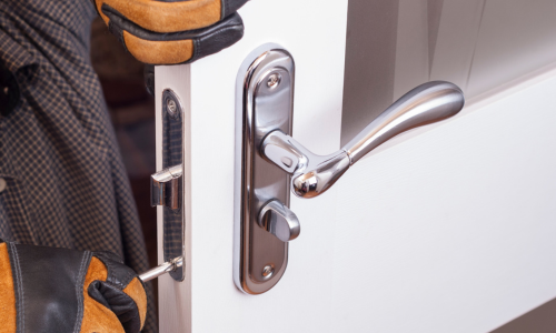 Man installing door lock